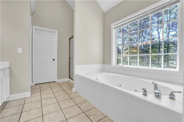 a spacious bathroom with a bathtub and a shower