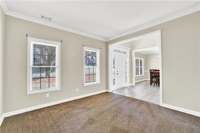 an empty room with windows and closet
