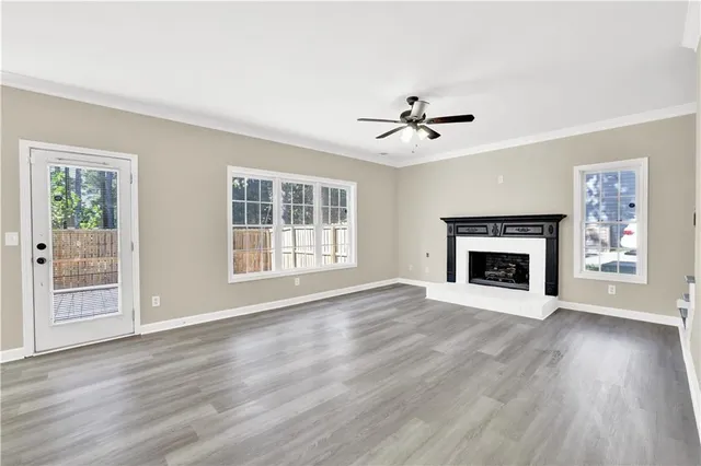 a view of an empty room with a fireplace and a window