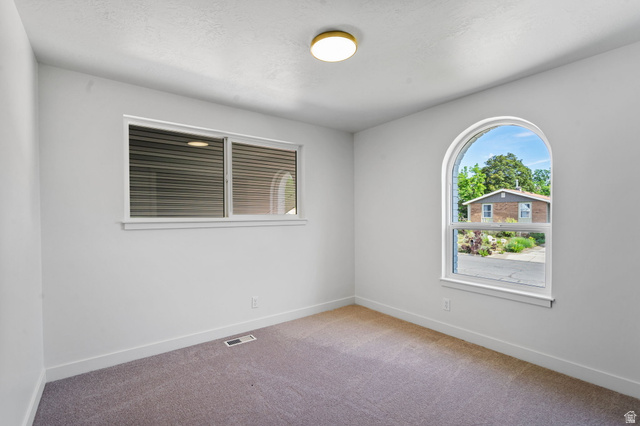 432 Calnette Drive Sandy, UT 84070 - Photo 21 of 48 Room featuring an arched window and a rectangular window with blinds