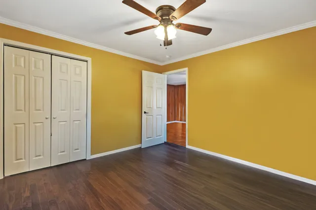 a view of a big room with wooden floor and a ceiling fan