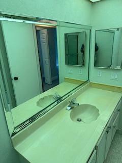 303 Racquet Club Road, Unit 201 Weston, FL 33326 - Photo 14 of 20 a bathroom with a sink and mirror