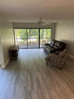 303 Racquet Club Road, Unit 201 Weston, FL 33326 - Photo 3 of 20 a living room with furniture and a large window