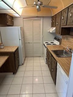 303 Racquet Club Road, Unit 201 Weston, FL 33326 - Photo 5 of 20 a kitchen with a sink a stove top oven and cabinets