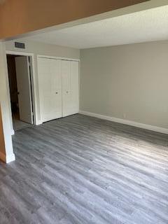 303 Racquet Club Road, Unit 201 Weston, FL 33326 - Photo 6 of 20 a view of an empty room with wooden floor and closet