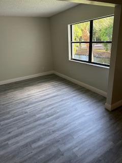 303 Racquet Club Road, Unit 201 Weston, FL 33326 - Photo 10 of 20 an empty room with wooden floor and windows