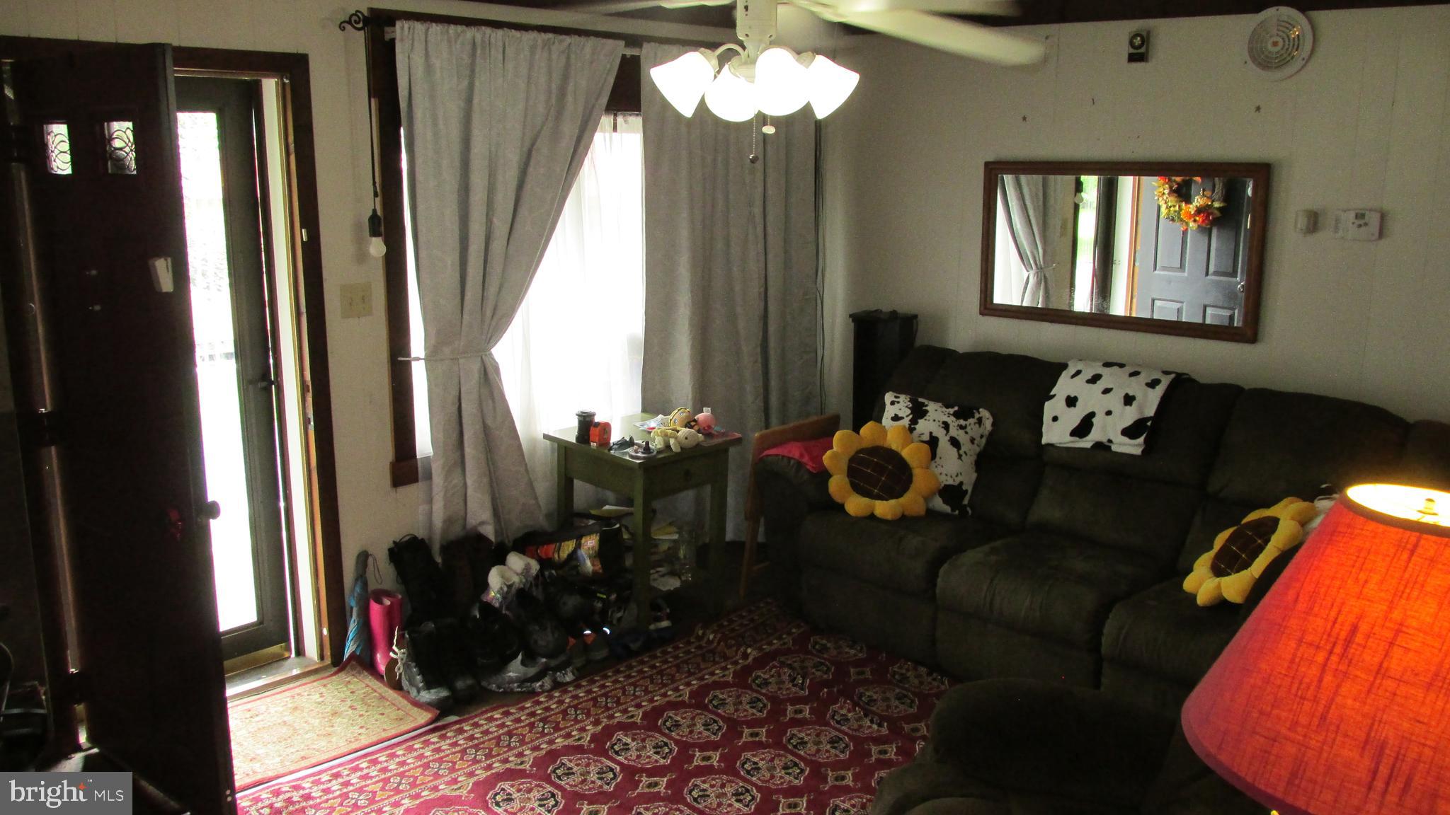 4897 Briggs Road Huntingdon, PA 16652 - Photo 23 of 29 a living room with furniture and a mirror