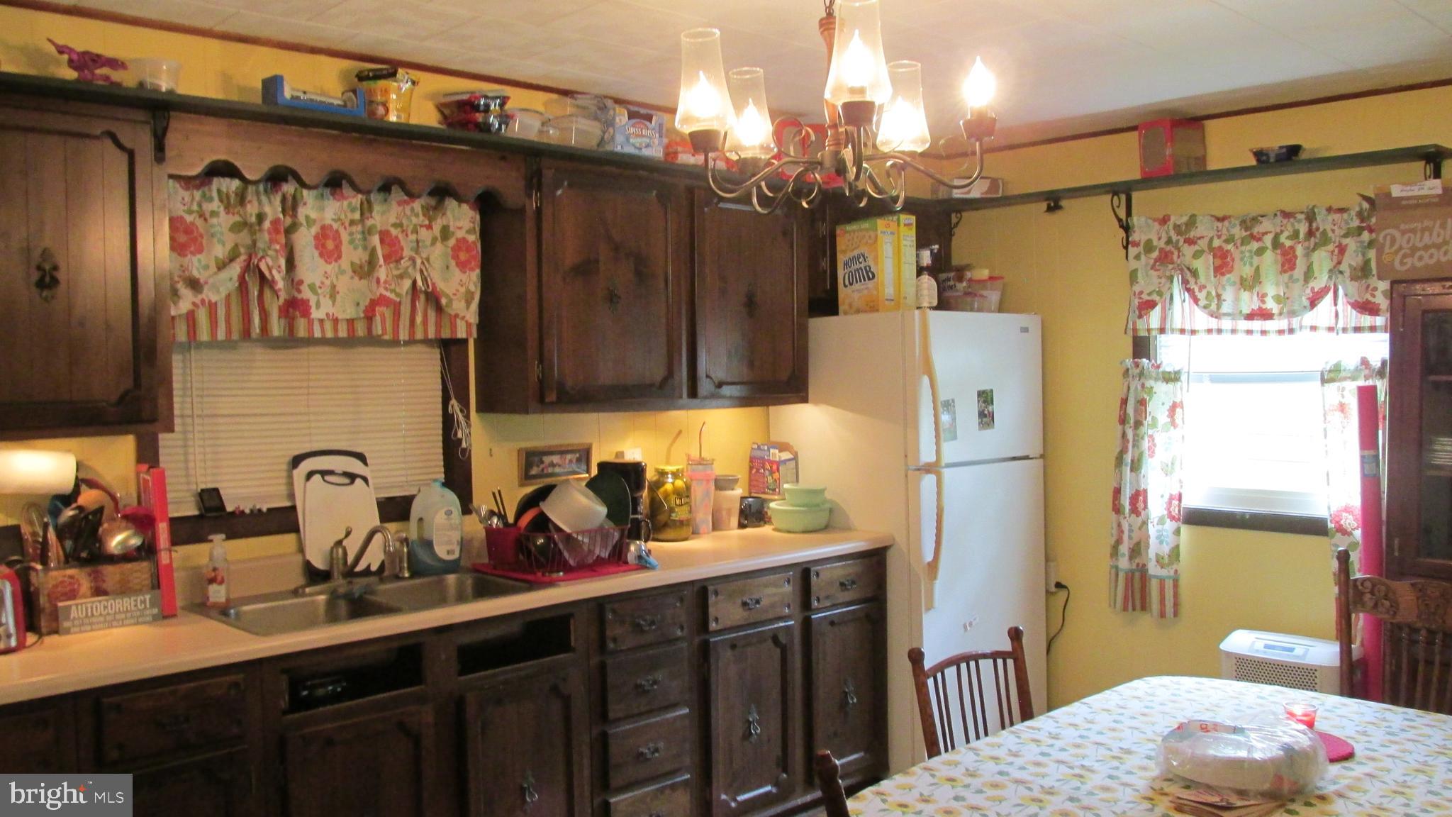 4897 Briggs Road Huntingdon, PA 16652 - Photo 29 of 29 a kitchen with a sink refrigerator and cabinets