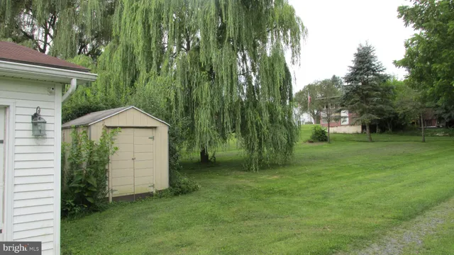 a view of an house with backyard space and garden