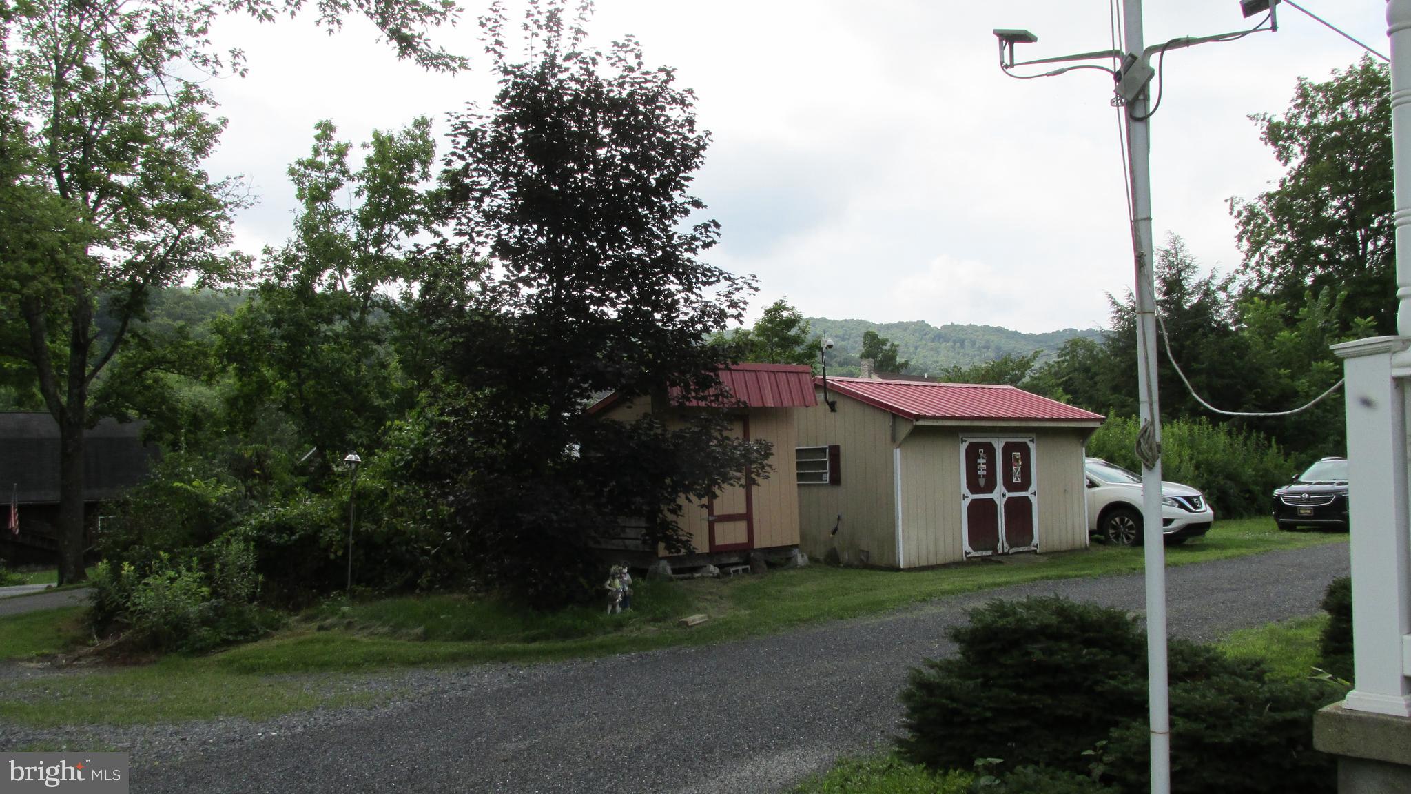 4897 Briggs Road Huntingdon, PA 16652 - Photo 7 of 29 a view of a white house with a yard and plants