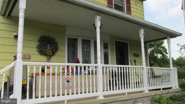 a view of a porch with a small yard