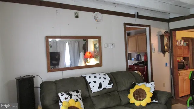 a living room with furniture and painting on the wall