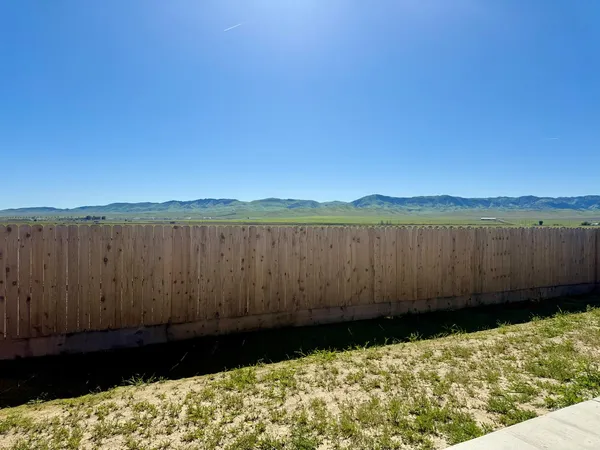 a view of pathway with wooden fence