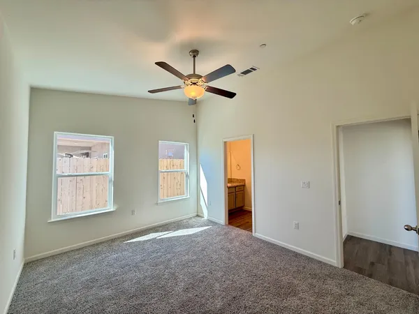 a view of a livingroom with a ceiling fan and window