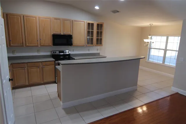 a kitchen with stainless steel appliances a stove a sink and a microwave