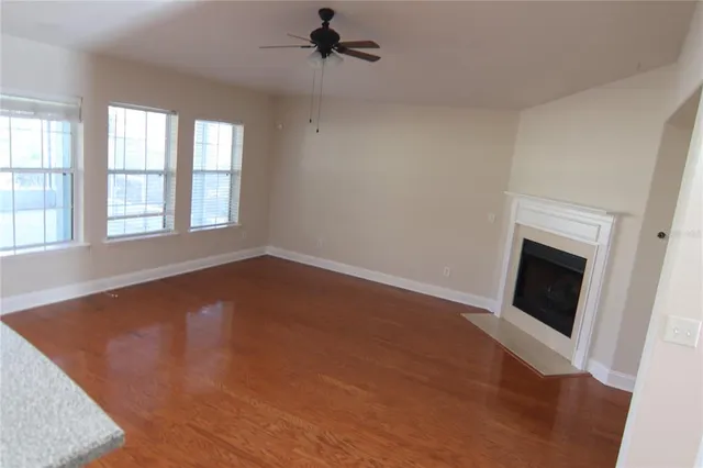 wooden floor in an empty room with a fireplace