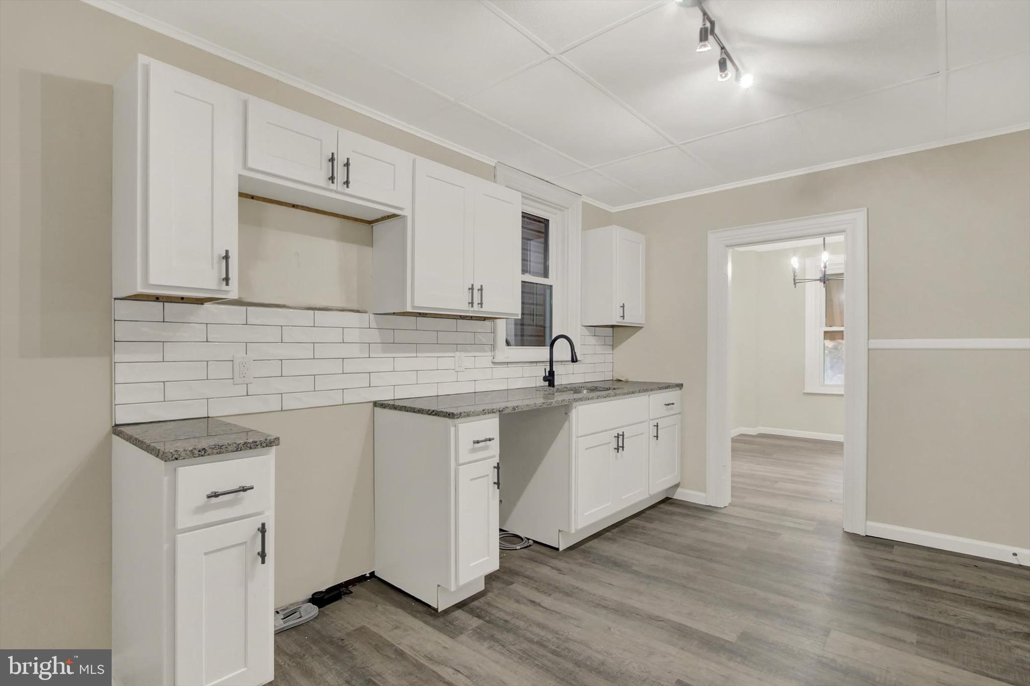 551 York Street Hanover, PA 17331 - Photo 8 of 24 a kitchen with white cabinets sink and white stainless steel appliances