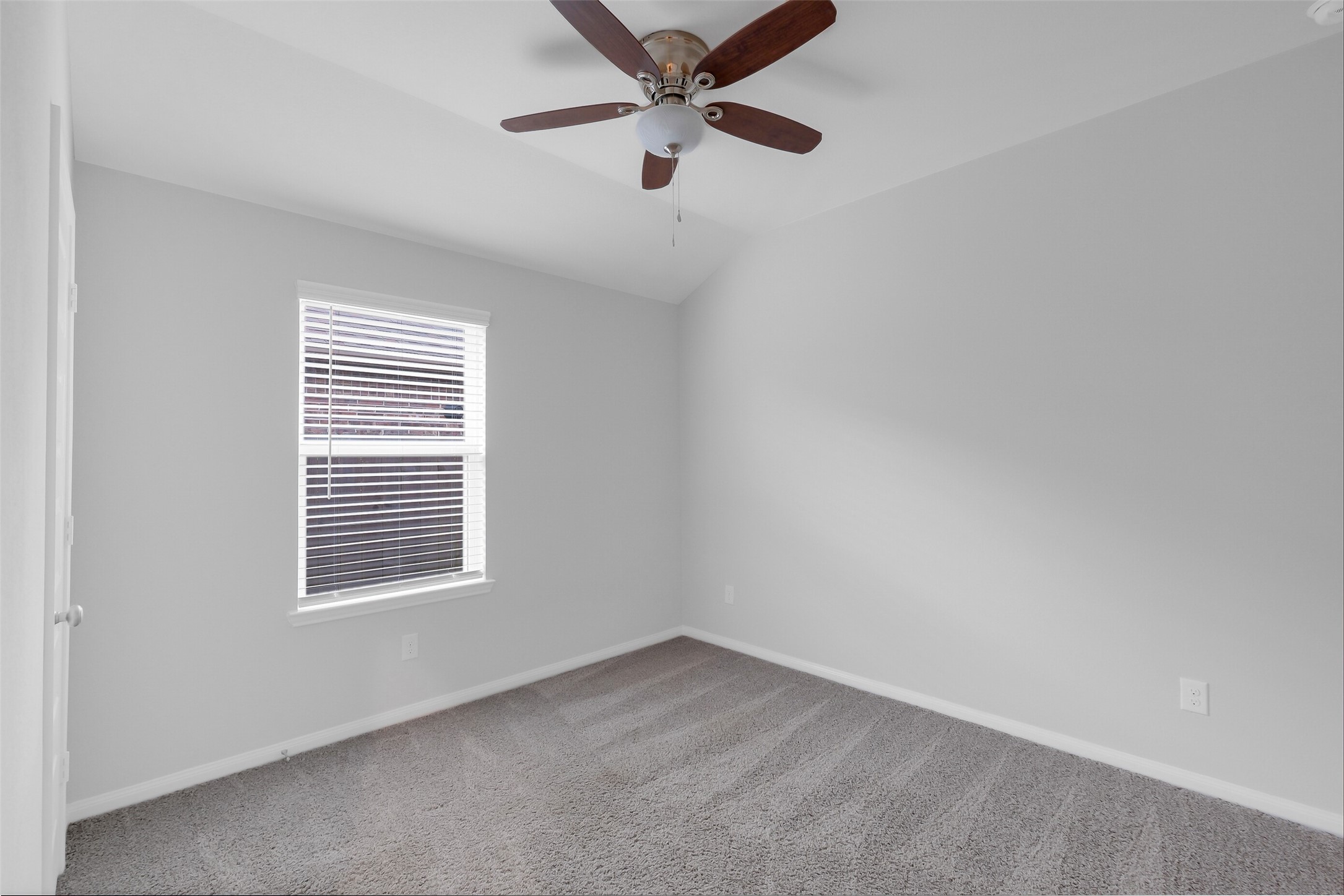 2442 Goddard Grn Drive Rosharon, TX 77583 - Photo 21 of 34 an empty room with a window and a ceiling fan
