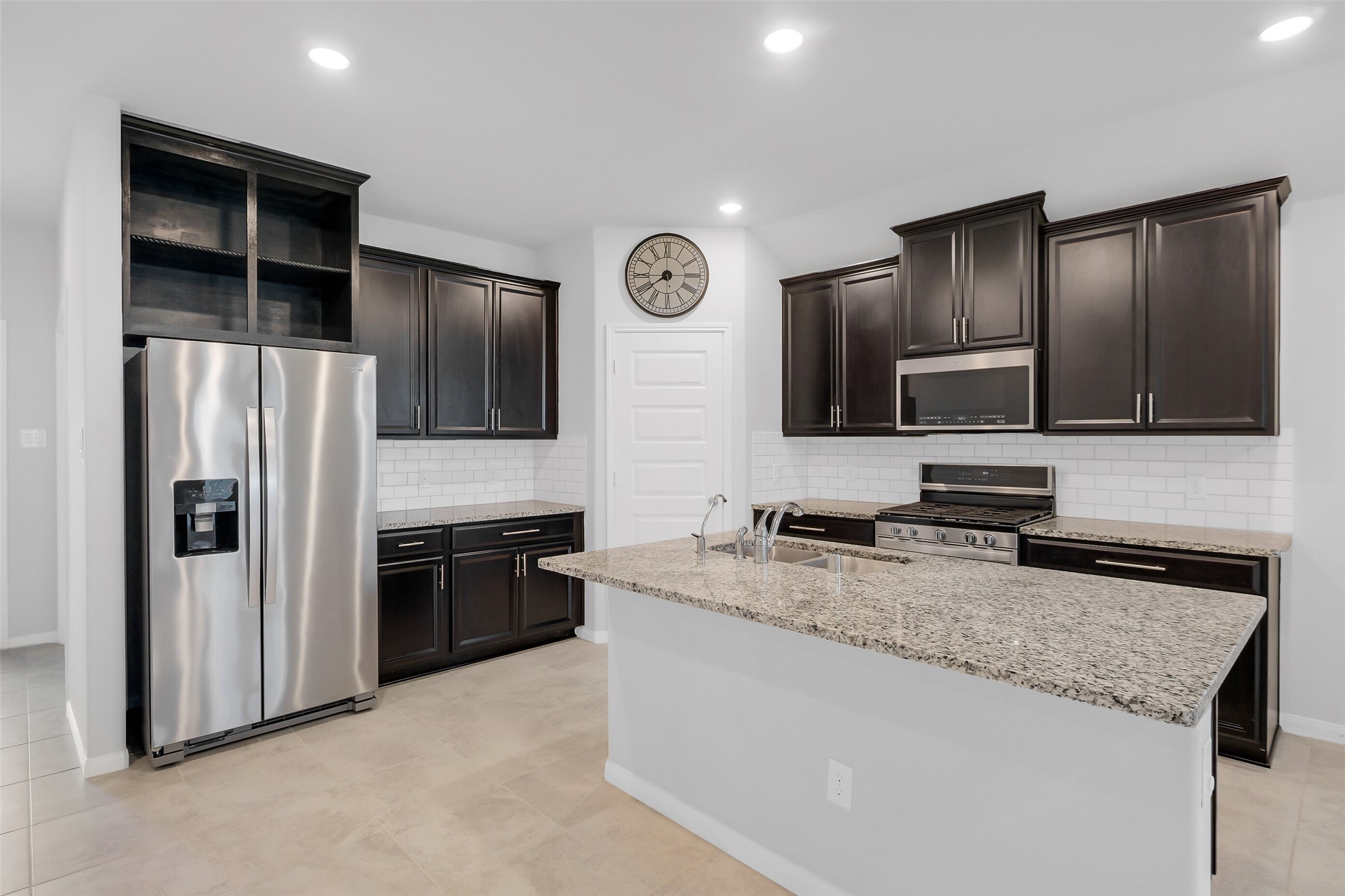 2442 Goddard Grn Drive Rosharon, TX 77583 - Photo 5 of 34 a kitchen with stainless steel appliances granite countertop a refrigerator a stove a sink and a microwave