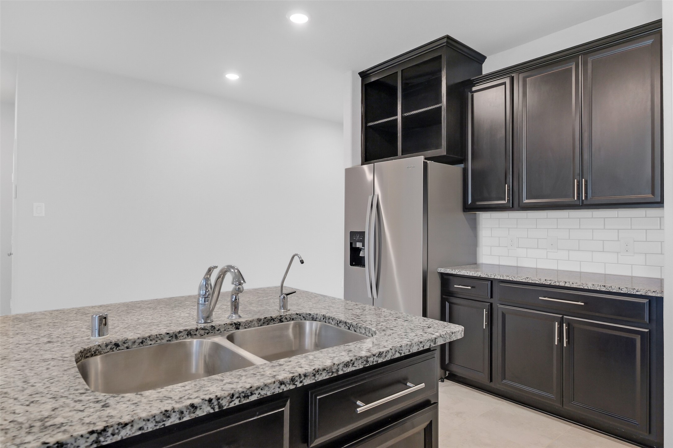 2442 Goddard Grn Drive Rosharon, TX 77583 - Photo 7 of 34 a kitchen with stainless steel appliances granite countertop a sink and a refrigerator