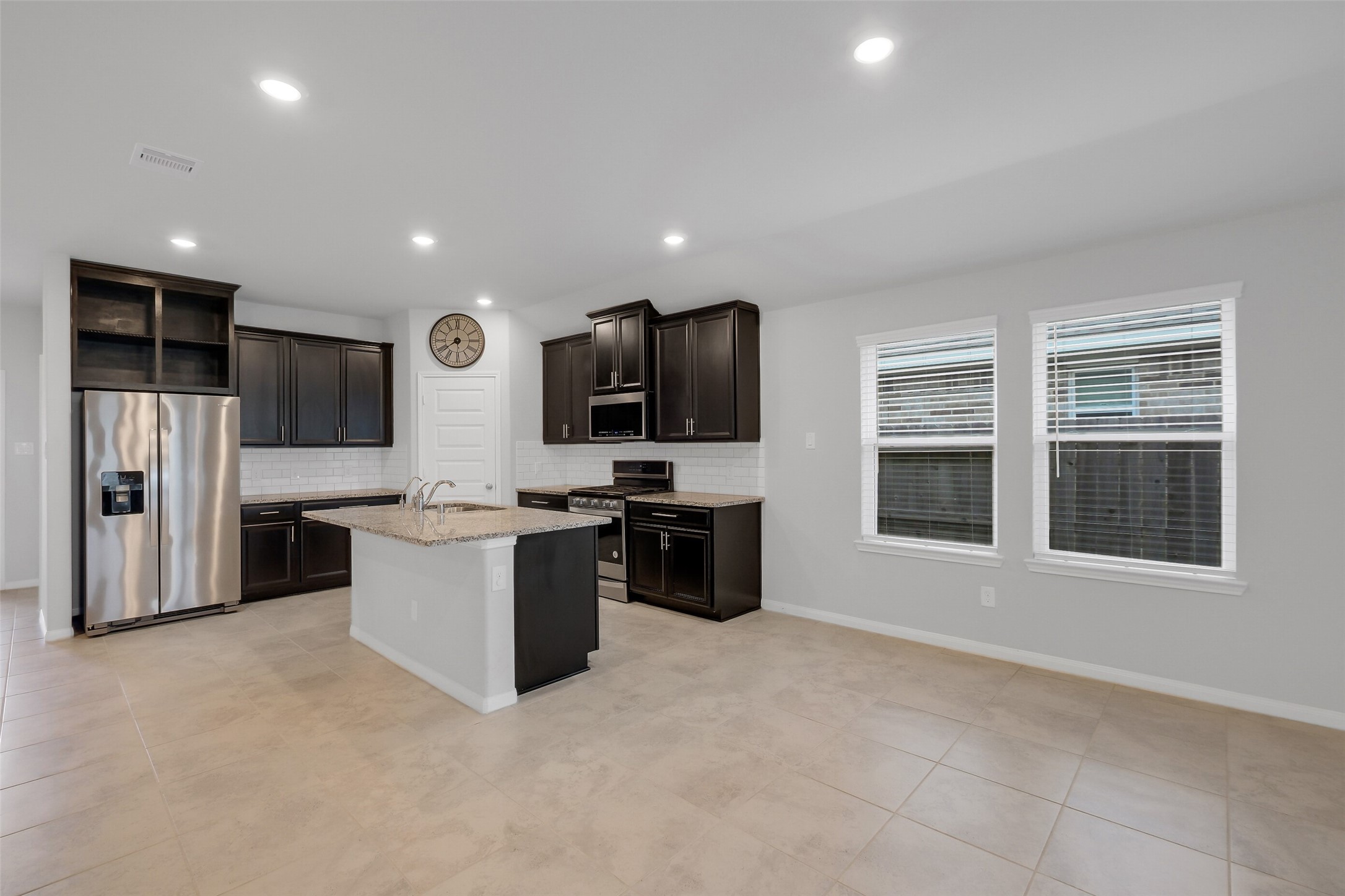 2442 Goddard Grn Drive Rosharon, TX 77583 - Photo 9 of 34 a large kitchen with a large counter top stainless steel appliances and cabinets