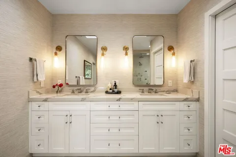 a bathroom with a double vanity sink and a mirror