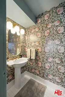 a bathroom with a sink toilet and window