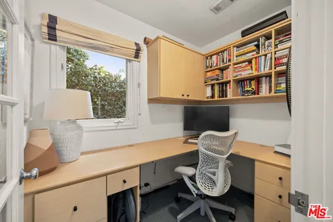 a room with a window and furniture