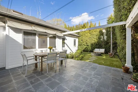 a view of a patio with table and chairs and potted plants