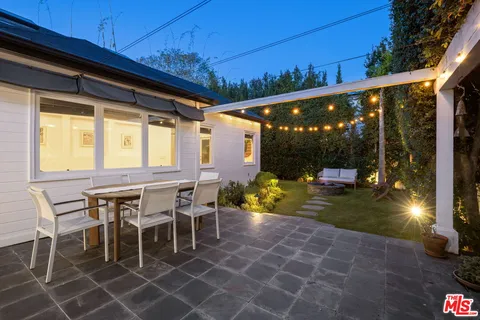 a outdoor space with a large window and furniture