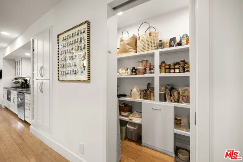 a cabinet with a book shelf and wooden floor