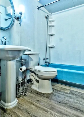 a bathroom with a sink a toilet and a mirror