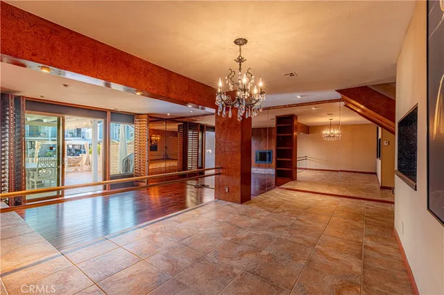 a view of empty room with wooden floor and floor to ceiling window