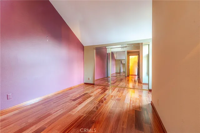 a view of an empty room and wooden floor