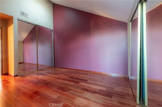 a view of an empty room and wooden floor