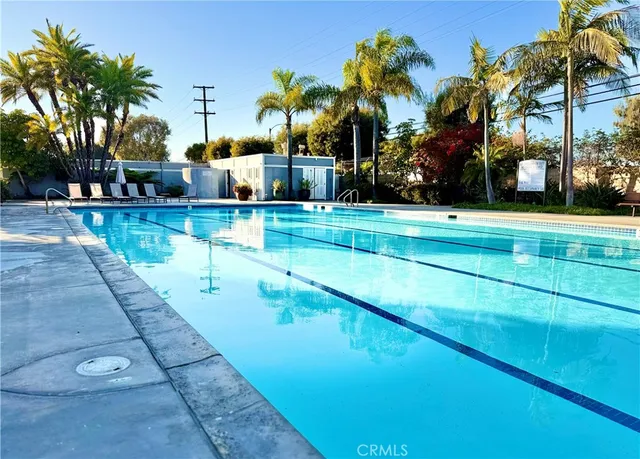 a view of swimming pool with outdoor seating and trees