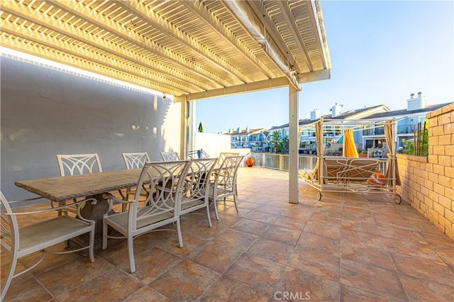 a view of a patio with a table and chairs