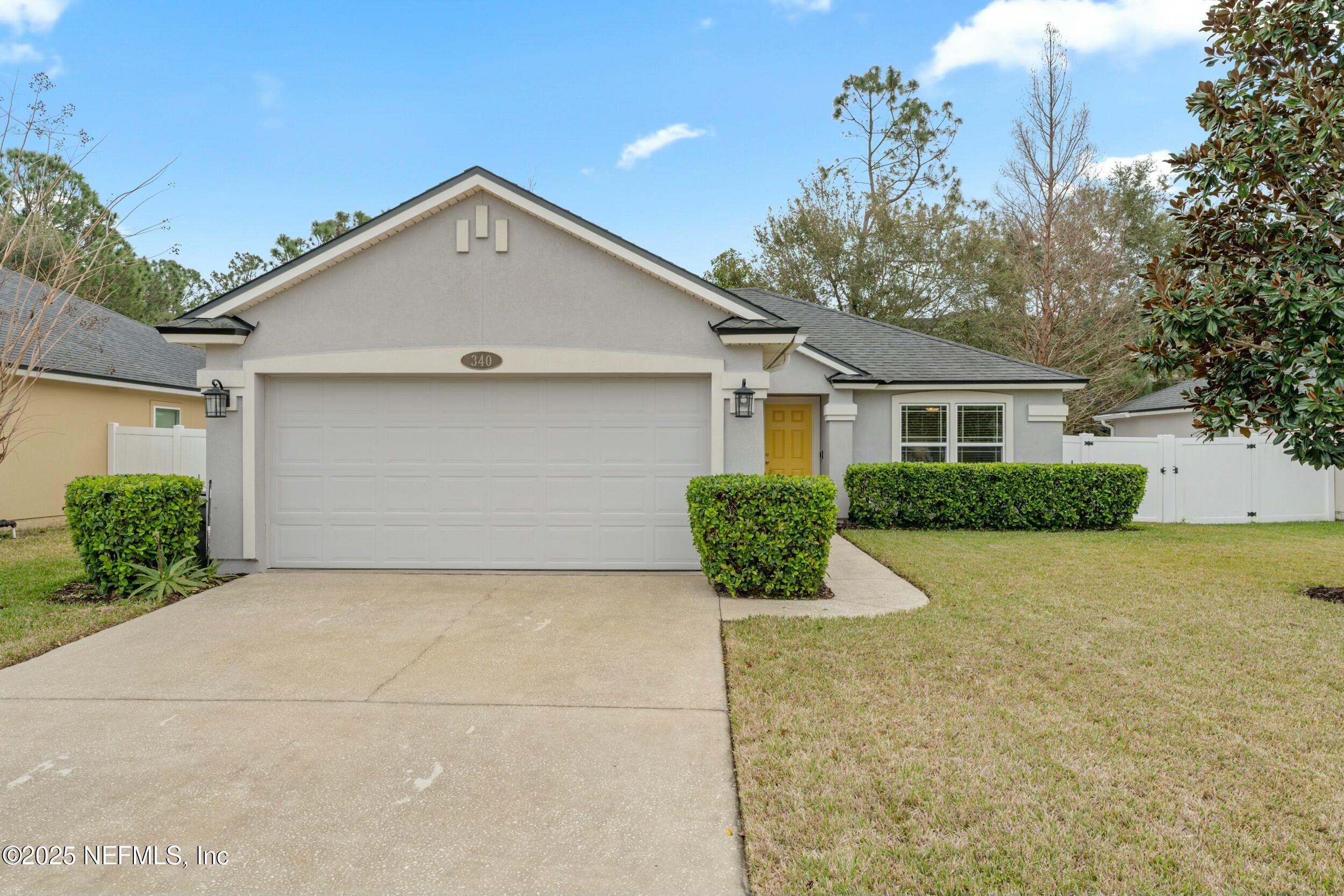 a view of backyard of house and garage