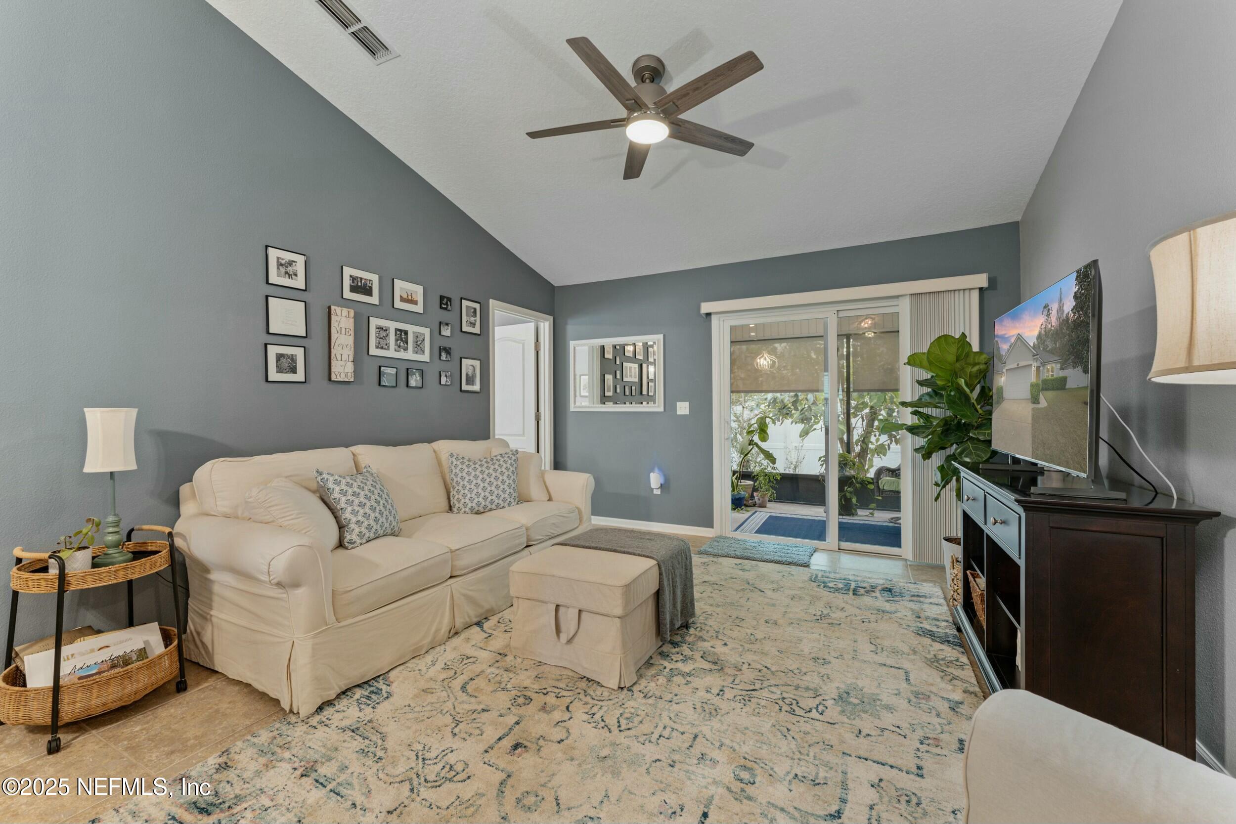 340 Sunshine Drive St. Augustine, FL 32086 - Photo 15 of 44 a living room with furniture a flat screen tv and a fireplace