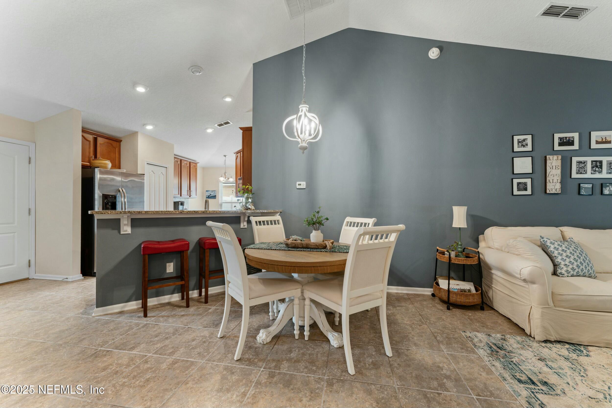 340 Sunshine Drive St. Augustine, FL 32086 - Photo 19 of 44 a view of a dining room with furniture and chandelier