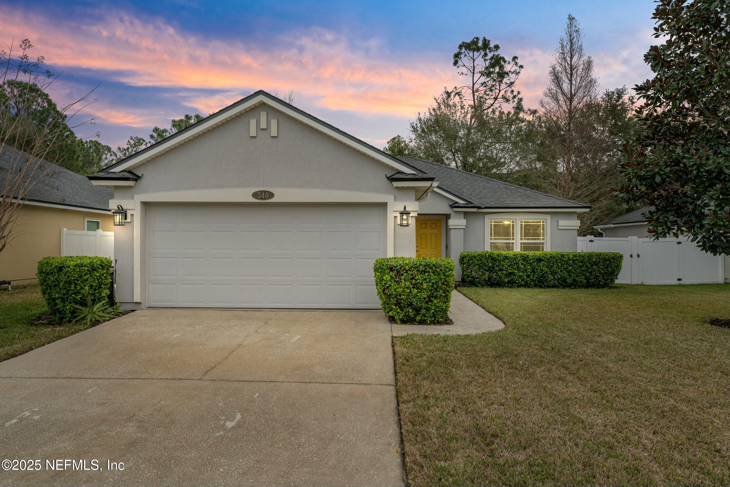 340 Sunshine Drive St. Augustine, FL 32086 - Photo 2 of 44 a front view of house with yard and trees around