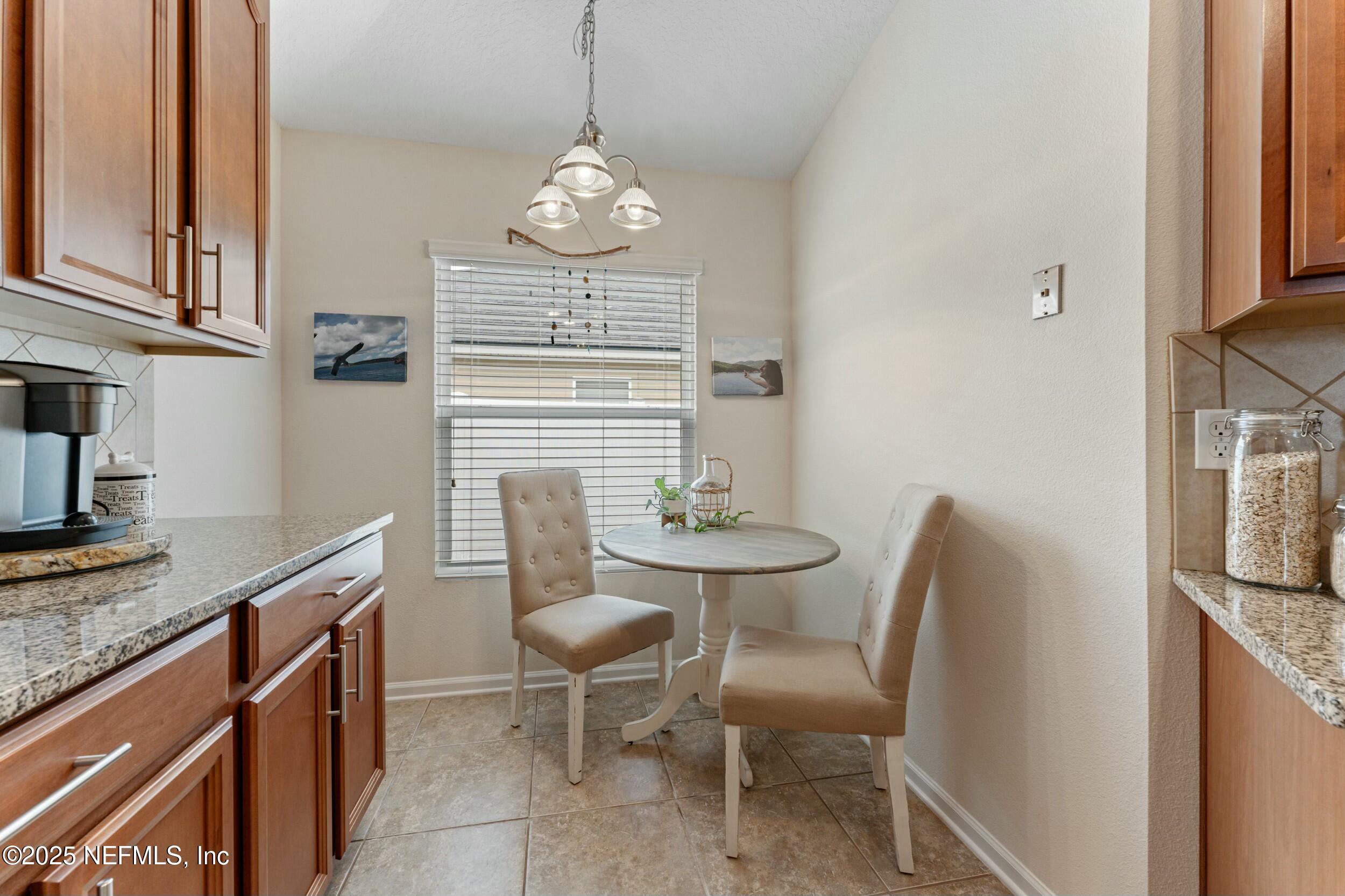 340 Sunshine Drive St. Augustine, FL 32086 - Photo 22 of 44 a view of kitchen and dining area with granite countertop cabinets
