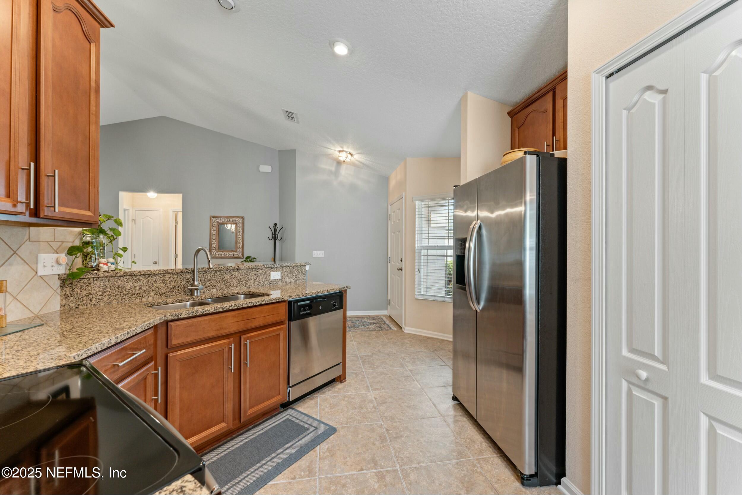 340 Sunshine Drive St. Augustine, FL 32086 - Photo 23 of 44 a kitchen with stainless steel appliances granite countertop a refrigerator and a sink