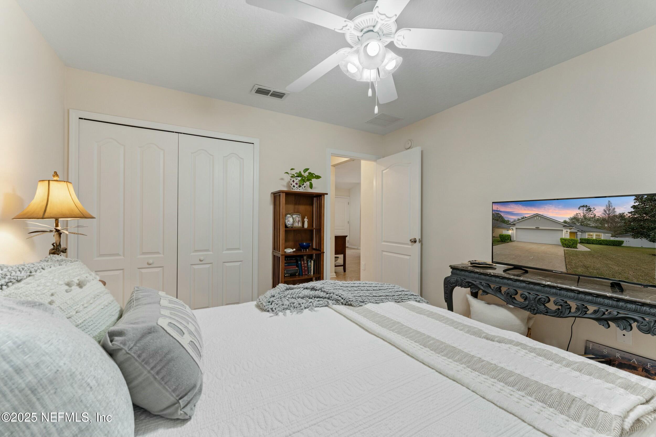 340 Sunshine Drive St. Augustine, FL 32086 - Photo 26 of 44 a bedroom with a bed and a flat screen tv