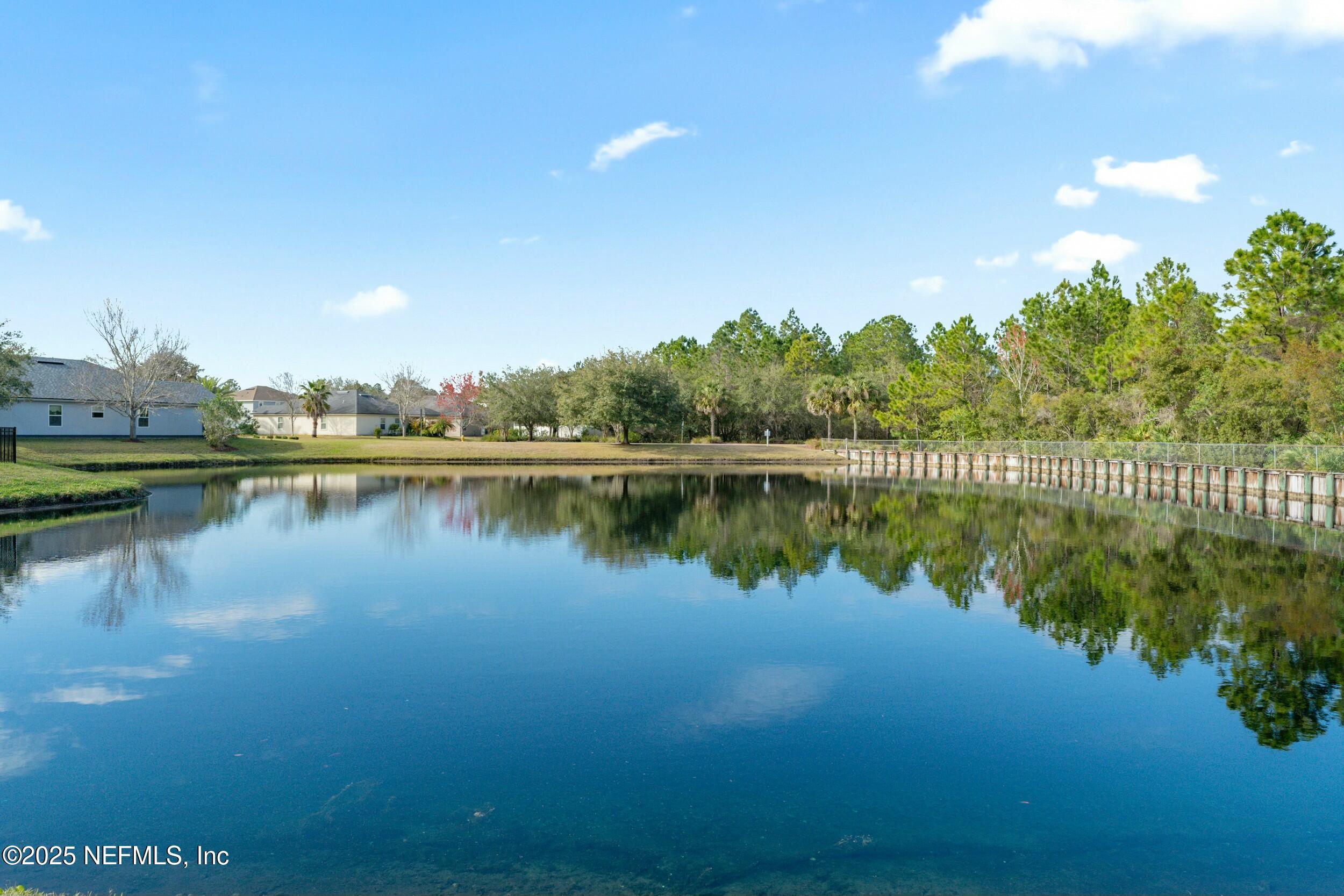 340 Sunshine Drive St. Augustine, FL 32086 - Photo 43 of 44 a view of a lake with houses in the back