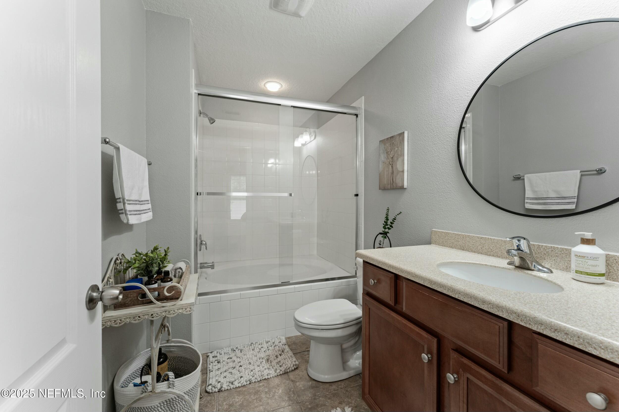 340 Sunshine Drive St. Augustine, FL 32086 - Photo 7 of 44 a bathroom with a sink a toilet and a mirror