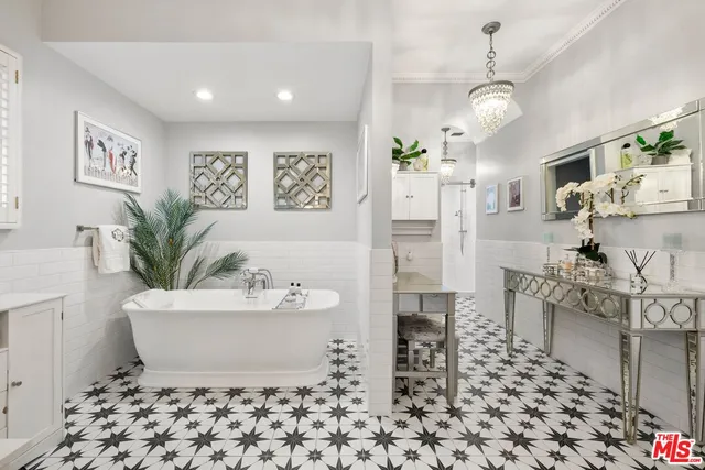 a white bath tub sitting in a bathroom next to a window