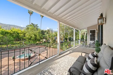 a balcony with furniture and a potted plant