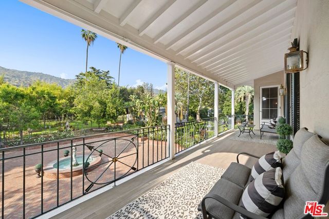 a balcony with furniture and a potted plant
