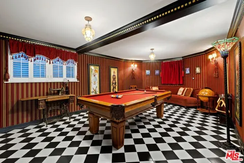 a room with pool table and glass windows